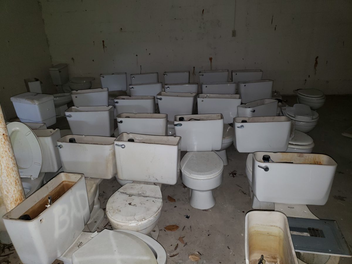 A room filled with lots of toilets and sinks.