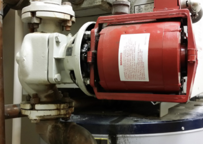 A red circulator pump worked on by Cinch Mechanical regarding plumbing work